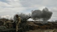 Ukrainian servicemen fire with a 105mm howitzer towards Russian positions near the city of Bakhmut, on March 8, 2023, amid the Russian invasion of Ukraine. (Photo by Aris Messinis / AFP)