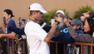 Carlos Alcaraz of Spain signs autographs during the BNP Paribas Open on March 08, 2023 in Indian Wells, California. Julian Finney/Getty Images/AFP 