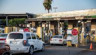 In this file photo taken on June 29, 2019 cars wait to cross into Brownsville, Texas from Matamoros, Mexico. - As reports swirl around the recent kidnapping in Mexico of four Americans, two of whom were killed, one detail has drawn particular attention -- they had crossed the border for a medical procedure. The revelation threw a spotlight on the steady stream of so-called medical tourism from the United States to its southern neighbor, as Americans cross the border seeking lower costs or treatments inaccessible at home, despite risks. (Photo by Sergio Flores / AFP)