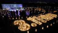 People attend a vigil with lanterns to mark the 12th anniversary of 2011 earthquake, tsunami and nuclear disaster, in Ishinomaki, Miyagi Prefecture on March 11, 2023. (Photo by JIJI PRESS / AFP)