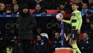 Manchester City's Spanish manager Pep Guardiola watches as Manchester City's English defender John Stones prepapres to take a throw-in during the English Premier League football match between Crystal Palace and Manchester City at Selhurst Park in south London on March 11, 2023. (Photo by Ben Stansall / AFP)
