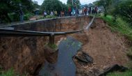 A general view of a collapsed road caused by flooding waters due to heavy rains following cyclone Freddy in Blantyre, Malawi, on March 13, 2013.  (Photo by Amos Gumulira / AFP)
 