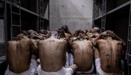 This handout picture released by the El Salvador's Presidency shows the second arrival of inmates belonging to the MS-13 and 18 gangs to the new prison 