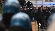 This photo obtained from Italian news agency Ansa shows Eintracht Frankfurt fans (Rear) facing anti-riot police (Front) within clashes on March 15, 2023 in downtown Naples prior to the UEFA Champions League round of 16, second leg football match between SSC Napoli and Eintracht Frankfurt to be played at the Diego-Maradona stadium in Naples. Photo by Ciro FUSCO / ANSA / AFP