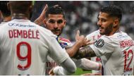 Houssem Aouar (centre) celebrates with team mates after scoring a goal during the French L1 football match between Lyon and Montpellier. OLIVIER CHASSIGNOLE / AFP
