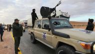 Libyan special forces in charge of illegal migration assemble in the southern region of Bani Walid, on January 14, 2023, ahead of their mission as part of a security plan to enforce inspections at points of entry through the desert borders. (AFP)