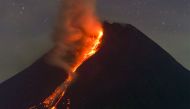 Mount Merapi volcano spews lava from its crater as seen from Sleman in Yogyakarta early on March 18, 2023. (Photo by Devi Rahman / AFP)