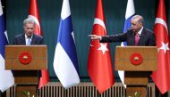 Turkish President Recep Tayyip Erdogan points towards Finnish President Sauli Niinisto during a joint press conference held after their meeting at the Presidential Complex in Ankara, on March 17, 2023. (Photo by Adem ALTAN / AFP)