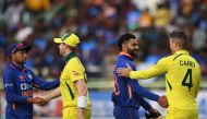 India's Virat Kohli (2R) and Kuldeep Yadav (L) shake hands with Australia's captain Steve Smith (2L) and Alex Carey at the end of the second one-day international (ODI) cricket match between India and Australia at the Y.S. Rajasekhara Reddy Cricket Stadium in Visakhapatnam on March 19, 2023. (Photo by Noah Seelam / AFP) 