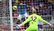Napoli's Nigerian forward Victor Osimhen scores a header and his side's third goal, past Torino's Serbian goalkeeper Vanja Milinkovic-Savic during the Italian Serie A football match between Torino and Napoli on March 19, 2023 at the Olympic stadium in Turin. (Photo by Marco BERTORELLO / AFP)