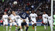 Rennes' Norwegian defender Birger Meling fights for the ball with Paris Saint-Germain's French forward Hugo Ekitike during the French L1 football match between Paris Saint-Germain (PSG) and Stade Rennais FC at The Parc des Princes Stadium in Paris on March 19, 2023. (Photo by Anne-Christine POUJOULAT / AFP)