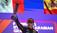Red Bull Racing's Mexican driver Sergio Perez celebrates with the trophy on the podium after winning the Saudi Arabia Formula One Grand Prix at the Jeddah Corniche Circuit in Jeddah on March 19, 2023. (Photo by Ben Stansall / AFP)
 