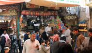 People gather at a market in Sanaa on March 18, 2023, ahead of the Muslim holy month of Ramadan. (Photo by Mohammed HUWAIS / AFP)