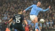 Manchester City's Norwegian striker Erling Haaland scores their second goal past Burnley's Northern Irish goalkeeper Bailey Peacock-Farrell during the English FA Cup quarter-final football match between Manchester City and Burnley at the Etihad Stadium in Manchester, north-west England, on March 18, 2023. (Photo by Oli SCARFF / AFP)

