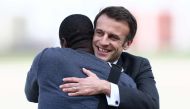 French President Emmanuel Macron greets freed French hostage journalist Olivier Dubois, who was held hostage in Mali for nearly two years by the Support Group for Islam and Muslims (GSIM), upon his arrival at the Villacoublay airport, in Velizy-Villacoublay, near Paris, on March 21, 2023. - French journalist Olivier Dubois was released on March 20, 2023. (Photo by YVES HERMAN / POOL / AFP)