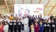 Minister of Sports and Youth H E Salah bin Ghanim Al Ali and Minister of Education and Higher Education H E Buthaina bint Ali Al Jabr Al Nuaimi with schoolchildren at the launch of the initiative for cooperation between the two ministries.