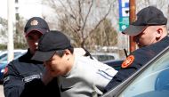 South Korean cryptocurrency entrepreneur co-founder of Terraform Labs (Terra Luna), Do Kwon (C) is taken to court after being arrested at the airport on March 24, 2023 in Podgorica.