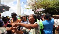 People take part in a protest to demand an electoral reform near the National Assembly in Paramaribo on March 24, 2023. (Photo by Ranu Abhelakh / AFP)