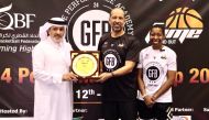 Engineer Ahmed Hammouda, Director General of Fame Sports Academy, presents a memento to QBF Secretary-General Saadoun Al Kuwari as a token of appreciation in the presence of coach Gigi Brown.