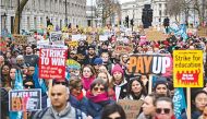 Teachers hold placards and flags during a protest as part of a national strike day in London recently. File photo / AFP