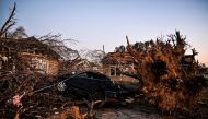The remains of a house and cars are entangled in tree limbs in Rolling Fork, Mississippi, on March 25, 2023, after a tornado touched down in the area. Photo by Chandan Khanna / AFP

