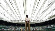 In this file photo taken on June 28, 2021, a member of Britain's armed forces stands on duty ahead of a men's singles first-round match, under the closed roof on Centre Court, on the first day of the 2021 Wimbledon Championships at The All England Tennis Club in Wimbledon, south-west London. (Photo by Glyn Kirk / AFP) 