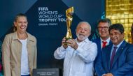 This handout picture released by the Brazilian Presidency shows Brazil's President Luiz Inacio Lula da Silva (centre), accompanied by the Sports Minister Ana Moser (left) and the President of the Brazilian Football Confederation Ednaldo Rodrigues, holding the FIFA Women's World Cup trophy during its presentation at the Planalto Palace in Brasilia on March 30, 2023. (Photo by Ricardo Stuckert / Brazilian Presidency / AFP) 