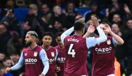 Aston Villa's Scottish midfielder John McGinn (right) celebrates after scoring his team second goal during the English Premier League football match between Chelsea and Aston Villa at Stamford Bridge in London on April 1, 2023. (Photo by JUSTIN TALLIS / AFP)