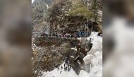 This handout photograph taken on April 4, 2023 and released by the Indian Army shows rescue workers gather at the site of avalanche that hit the Gangtok-Natu La road in India's north-eartern state Sikkim. Photo by INDIAN ARMY / AFP