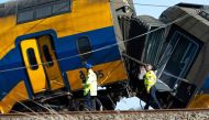Members of emergency services works at the accident site of a derailed train in Voorschoten, on April 4, 2023. (Photo by Nick Gammon / AFP)