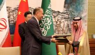 This handout picture provided by the Iranian foreign ministry shows Iran's Foreign Minister Hossein Amir-Abdollahian (2nd L) shaking hands with Saudi Foreign Affairs Minister Prince Faisal bin Farhan (R) exchange folders next to Chinese Foreign Minister Qin Gang (L) during a meeting in Beijing on April 6, 2023. (Photo by Iranian Foreign Ministry / AFP) 