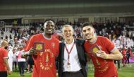 Al Duhail coach Hernan Crespo (centre) poses for a picture with Michael Olunga (left) and Karim Boudiaf after winning Qatar Cup final against Al Sadd at Jassim Bin Hamad Stadium on Thursday night.    