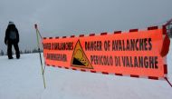 This file photo taken on February 13, 2016, shows a banner indicating a high risk of avalanche placed at the top of the slopes in the Haute Savoie resort of Les Carroz d'Araches. (Photo by Denis Charlet / AFP)
