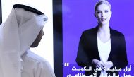 A journalist watches an introductory video by the 'artificial intelligence' anchor Fedha on the twitter account of Kuwait News service, in Kuwait City on April 9, 2023. (Photo by YASSER AL-ZAYYAT / AFP)