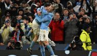 Manchester City's Norwegian striker Erling Haaland (R) celebrates with Manchester City's Portuguese midfielder Bernardo Silva (L) after scoring their third goal during the UEFA Champions League quarter final, first leg football match between Manchester City and Bayern Munich at the Etihad Stadium in Manchester, north-west England, on April 11, 2023. (Photo by Paul ELLIS / AFP)
