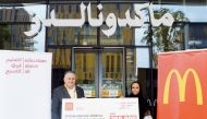 General Manager of McDonald’s Qatar Mithqual Abunasser (left) hands over a ceremonial cheque to Director of Partnerships at EAA Foundation Taj Sulaiman.