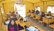 Students taking lessons in a facility provided by QRCS under its education support project in Afghanistan.