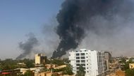 Smoke billows above residential buildings in Khartoum on April 16, 2023, as fighting in Sudan raged for a second day in battles between rival generals. (Photo by AFP)