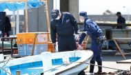 Police officers investigate Saikazaki port, where Japan's Prime Minister Fumio Kishida was evacuated unharmed from the scene of an apparent 