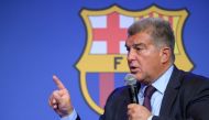 Barcelona's President Joan Laporta presents documents as he addresses a press conference at the Camp Nou stadium in Barcelona on April 17, 2023. Photo by LLUIS GENE / AFP