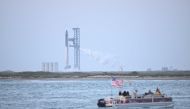 People wait on a boat to watch the launch of the SpaceX Starship rocket from South Padre Island, Texas on April 17, 2023. Photo by Patrick T. Fallon / AFP