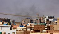 Smoke billows over residential buildings in eastern Khartoum on April 22, 2023, during ongoing battles between the forces of two rival generals. (Photo by AFP)