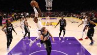 LeBron James #6 of the Los Angeles Lakers scores over Luke Kennard #10 of the Memphis Grizzlies during Game Three of the Western Conference First Round Playoffs at Crypto.com Arena on April 22, 2023 in Los Angeles, California.  Harry How / Getty Images via AFP