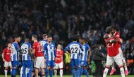 Manchester United's English defender Luke Shaw (C) commiserates Brighton players after Manchester United won a penalty shoot out during the English FA Cup semi-final football match between Manchester United and Brighton and Hove Albion at Wembley Stadium in north west London on April 23, 2023. (Photo by Glyn KIRK / AFP) 