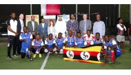 The Ugandan team pose with officials during the closing ceremony. 
