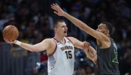 Nikola Jokic #15 of the Denver Nuggets is guarded by Rudy Gobert #27 of the Minnesota Timberwolves in the second quarter during Round 1 Game 5 of the NBA Playoffs at Ball Arena on April 25, 2023 in Denver, Colorado. Matthew Stockman/Getty Images/AFP