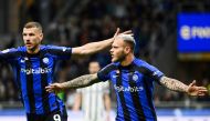 Inter Milan's Italian defender Federico Dimarco (R) celebrates after scoring his team's first goal during the Italian Cup semi-final second leg football match between Inter Milan and Juventus at the Giuseppe-Meazza (San Siro) stadium in Milan, on April 26, 2023. (Photo by Isabella BONOTTO / AFP)
