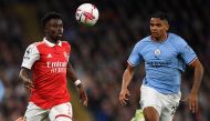 Manchester City's Swiss defender Manuel Akanji (R) vies against Arsenal's English midfielder Bukayo Saka during the English Premier League football match between Manchester City and Arsenal at the Etihad Stadium in Manchester, northwest England, on April 26, 2023. Photo by Oli SCARFF / AFP