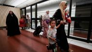 People evacuated from Sudan arrive at Baghdad International Airport on April 27, 2023. (Photo by AHMED AL-RUBAYE / AFP)