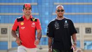 Ferrari’s Carlos Sainz Jr (left) and Mercedes’ Lewis Hamilton walk together after a press conference in Baku, yesterday. AFP 